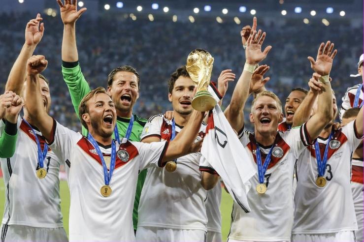 The German national football team celebrating with the World Cup trophy