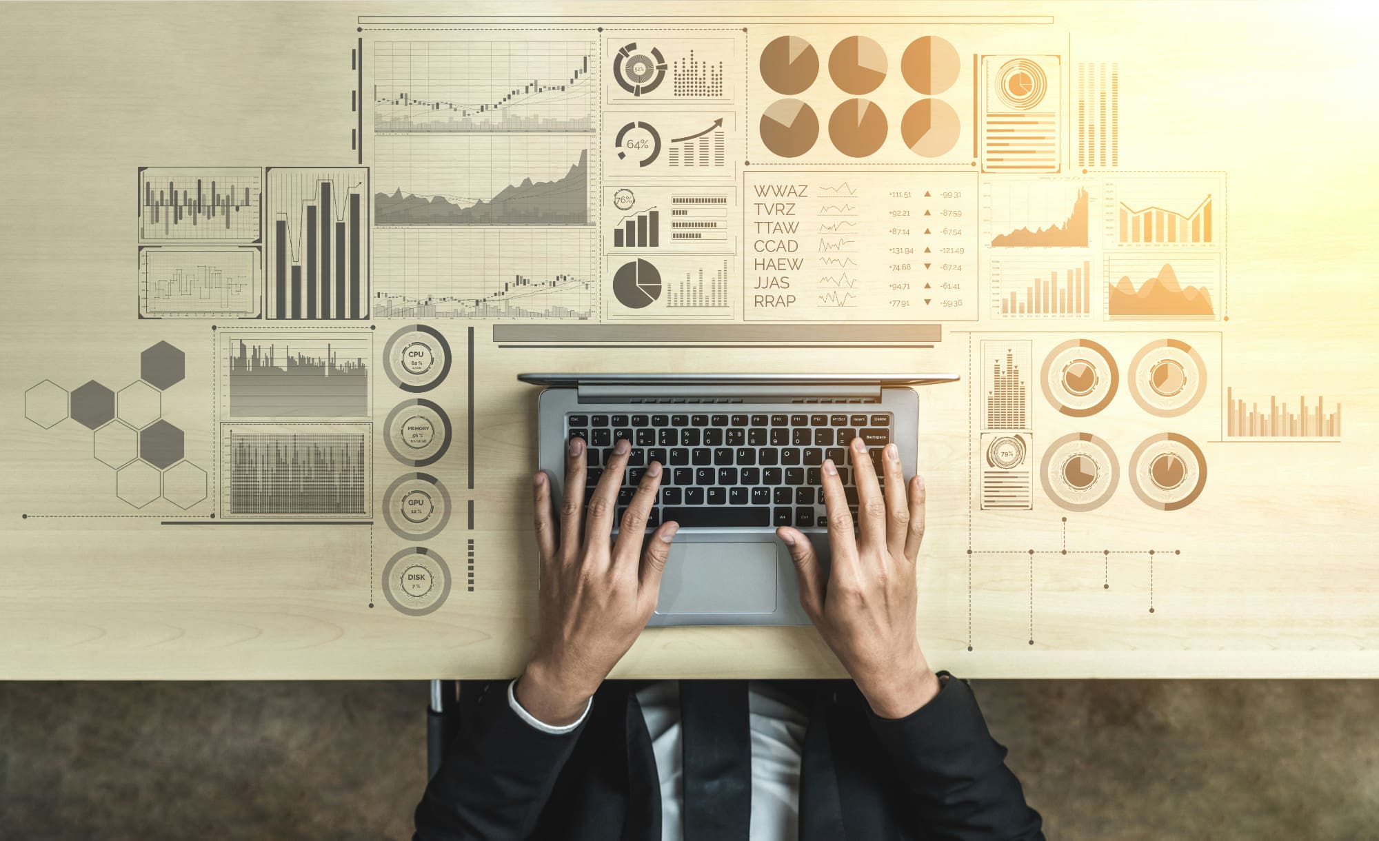 An above-view image of somebody typing on laptop keyboard, with laptop surrounded by super-imposed business graphs.